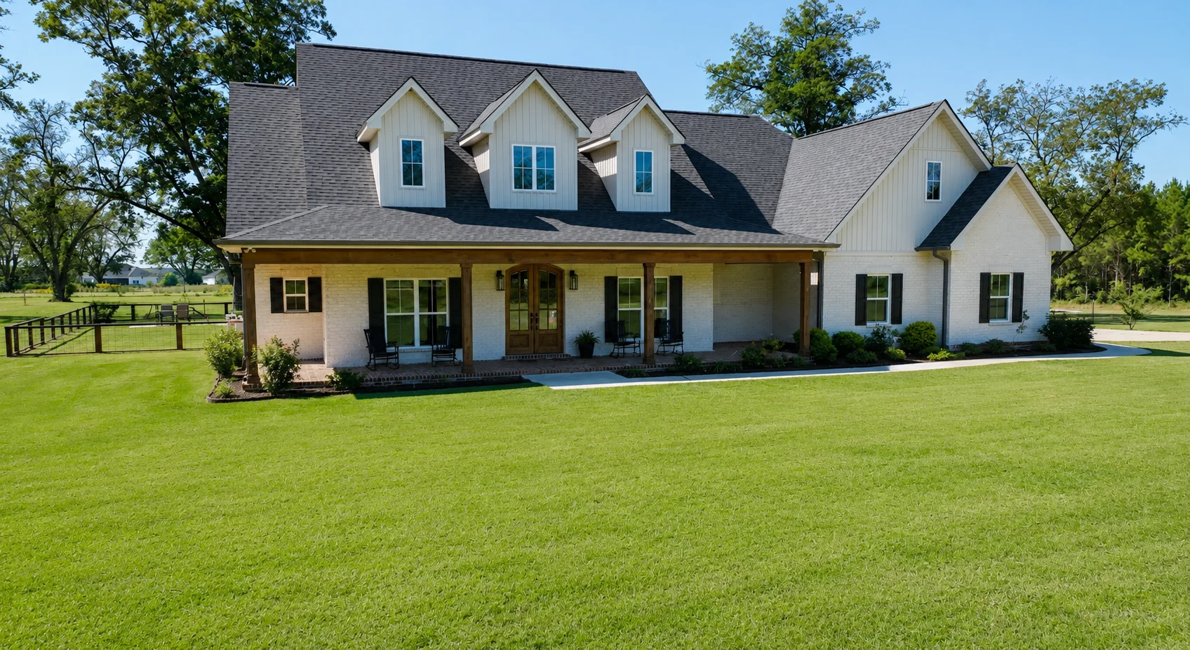 Five Line Homes custom white brick exterior with a green front lawn