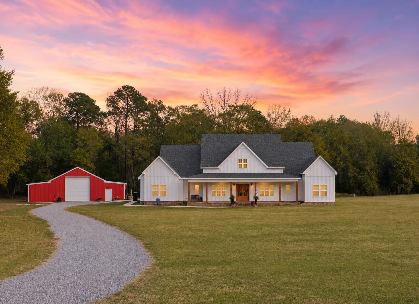 Five Line Homes custom farmhouse exterior at sunset with a red barn